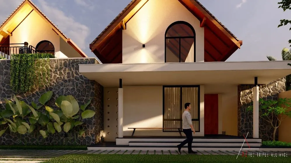 A modern house with a stone wall, lush greenery, and a man walking towards the entrance under a clear sky.